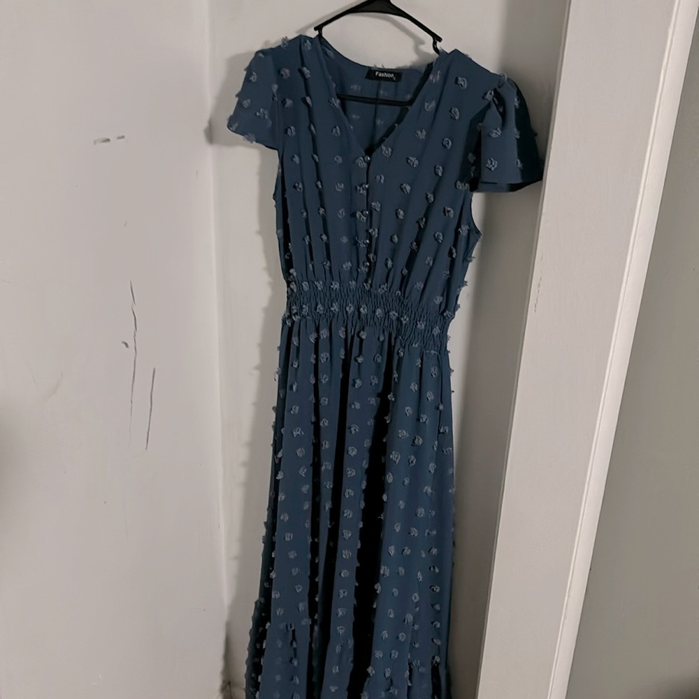 V-Neck, long blue tiered dress with ruffle short sleeves and yarn poofs.